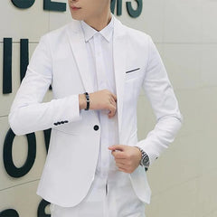 A man wears a slim-fit white formal blazer with a single button and notched lapels.
