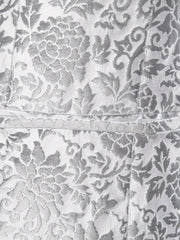 A close-up of a silver and grey patterned fabric on a men's suit jacket.