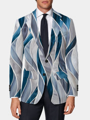 A man wears a slim fit blazer featuring a blue and grey abstract wave pattern.
