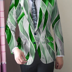 A man wears a slim-fit blazer featuring a green and white abstract wavy print.