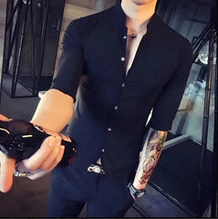 A man wears a black slim-fit shirt with a stand-up collar and half sleeves.