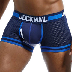 A man wearing navy blue mesh boxer briefs with a JOCKMAIL branded waistband.