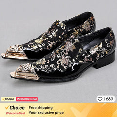 A pair of black pointed-toe dress shoes featuring a floral pattern and gold metal toe caps.