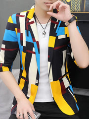 A man wears a slim-fit, half-sleeve blazer featuring a colorful geometric pattern.