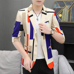 A man wears a slim-fit, half-sleeve blazer featuring a colorful geometric pattern.