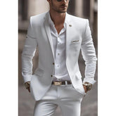 A man wearing a slim-fit white two-piece suit with a notch lapel and single-breasted jacket.