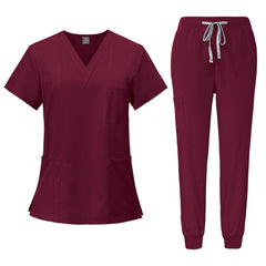 A burgundy V-neck scrub top and matching jogger pants with a drawstring waist.