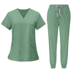 A sage green V-neck scrub top and matching jogger pants with a drawstring waist.