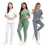 Three women wearing V-neck scrub sets with short-sleeved tops and jogger-style pants.