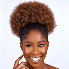 A woman wears a 10-inch kinky curly brown afro puff drawstring ponytail extension.
