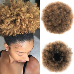 A kinky curly afro puff drawstring ponytail hairpiece in an ombre brown color.