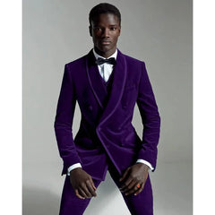 A man wears a slim-fit purple velvet three-piece suit with a black bow tie.