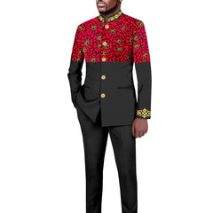 A man wears a two-piece suit featuring a black blazer with a red patterned upper section and matching trousers.