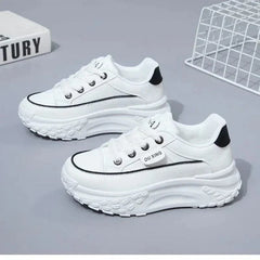 A pair of white platform sneakers with black trim and a lace-up closure.