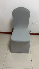A light gray, one-piece stretch chair cover fitted over a banquet chair.
