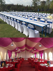 White chair covers with blue sashes arranged on tables for an outdoor wedding banquet.