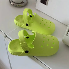 A pair of lime green EVA hole shoes with adjustable buckled heel straps on a white surface.