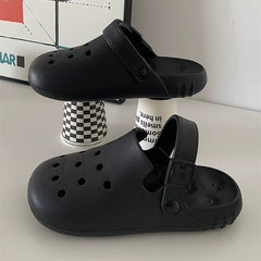 A pair of black EVA foam clogs with ventilation holes and an adjustable heel strap.
