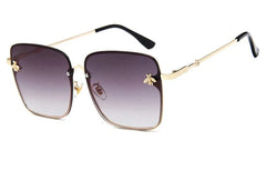 Oversized rimless square sunglasses for women featuring a gradient lens and small gold bee accents.