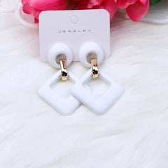 A pair of white geometric hollow square acrylic dangle earrings with gold-tone metal hoops.