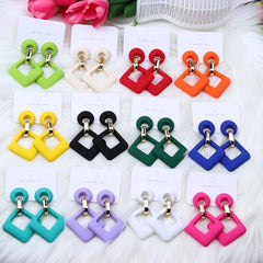 A collection of colorful geometric hollow square acrylic dangle earrings on display cards.