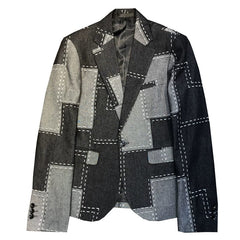 A slim-fit wool suit jacket featuring a patchwork design with contrasting grey and black panels.