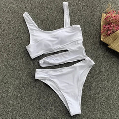 A white one-piece swimsuit with an asymmetrical strap, cut-out midriff, and chest pads.