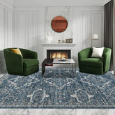 A rectangular rug with a blue and white vintage-inspired pattern placed in a living room.