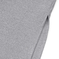 A close-up view of a grey ribbed knit fabric featuring a side slit detail.
