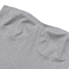 A close-up of a grey strapless knit top featuring a structured bustier-style design.