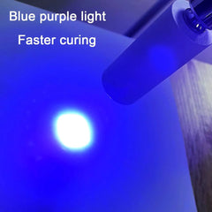 A handheld ultraviolet lamp emits a bright blue-purple light onto a surface.