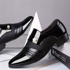 A pair of black pointed-toe slip-on dress shoes with textured panels and metallic accents.