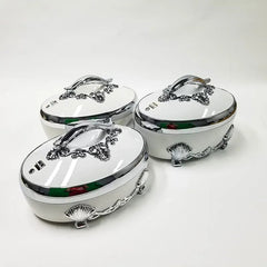 A set of three white oval thermal food containers with ornate silver handles and shell-shaped feet.