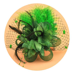A green vintage-style bridal hair clip featuring fabric flowers, feathers, and a mesh veil.
