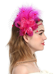 A woman wears a vibrant fuchsia fascinator featuring a large fabric flower, feathers, and netting.
