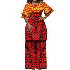 A woman wears a two-piece Polynesian-style outfit featuring a red and black patterned skirt and top.