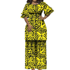 A woman wears a yellow and black Polynesian-print two-piece suit with a ruffled-sleeve top.