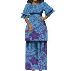 A woman wears a blue and purple Polynesian-print two-piece dress with ruffled sleeves.