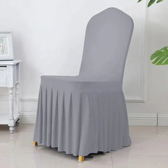 A grey, stretchable chair cover with a pleated skirt designed for banquet or dining chairs.