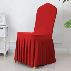 A red, elastic spandex chair cover featuring a pleated skirt design.