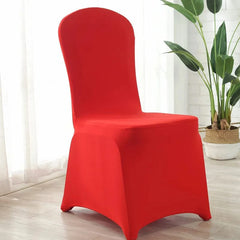 A bright red, stretchable spandex slipcover fitted over a dining chair.