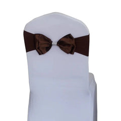 A brown satin chair sash with a pre-tied bow and a decorative rhinestone buckle.