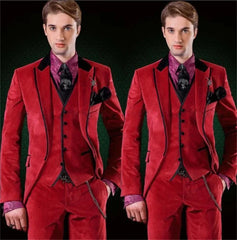 A man wears a three-piece red velvet suit with a purple patterned shirt and black accents.