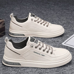 A pair of white casual men's sneakers with lace-up closures and grey accents on the soles.