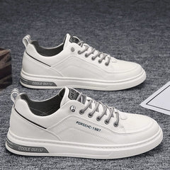 A pair of white casual men's sneakers with grey laces and a low rubber sole.