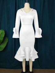 A white V-neck midi dress with long flare sleeves, shoulder cutouts, and a ruffled hem.