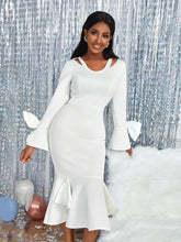 A white long-sleeve midi dress with a V-neck, bow-tie cuffs, and a ruffled hem.