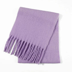 A solid light purple winter scarf with a soft texture and fringed ends.