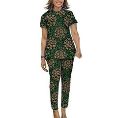 A woman wears a matching green short-sleeved top and pants set featuring a circular Ankara print.