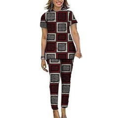 A woman wears a matching short-sleeve top and pants set featuring a geometric red and white pattern.